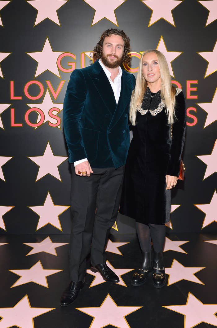 Aaron and Sam Taylor-Johnson stand together with their arms around each other