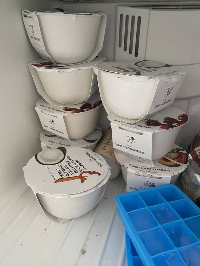 Eight Daily Harvest meals stacked on top of each other in Shelby&#x27;s freezer