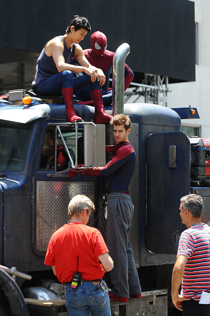 Andrew standing next to a truck with two of his Spider-Man body doubles on top of the truck