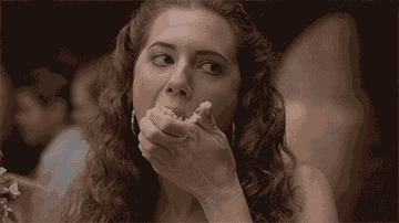 GIF woman with food on her face