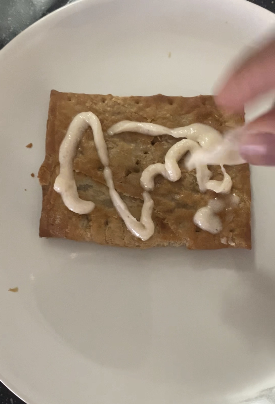 a toaster strudel with icing on a plate