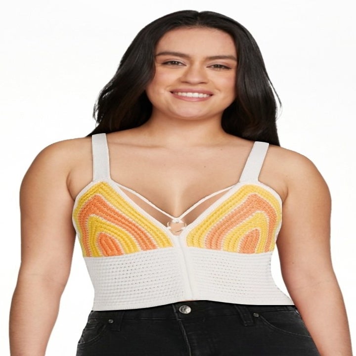 a model wearing the white, yellow and orange crochet top
