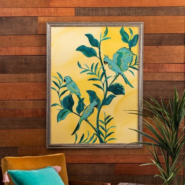 The yellow and teal framed artwork on the wall