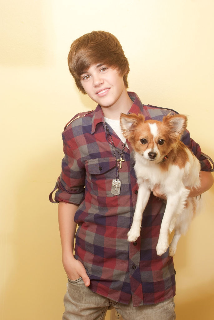 a young Justin Bieber holding a puppy