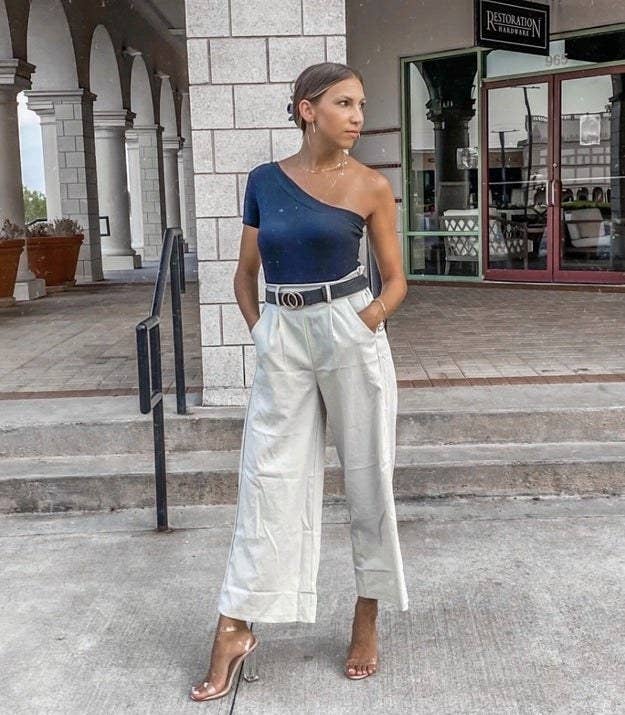 a reviewer wearing the linen pants with heels and a one sleeve top