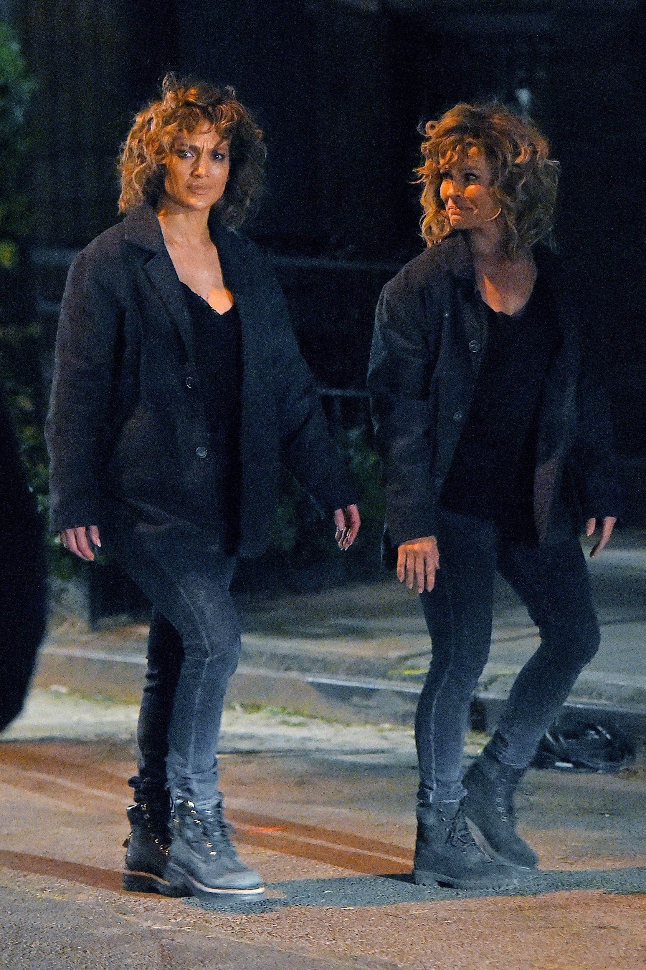 JLo and her body double walking and wearing ankle boots, leggings, and jackets