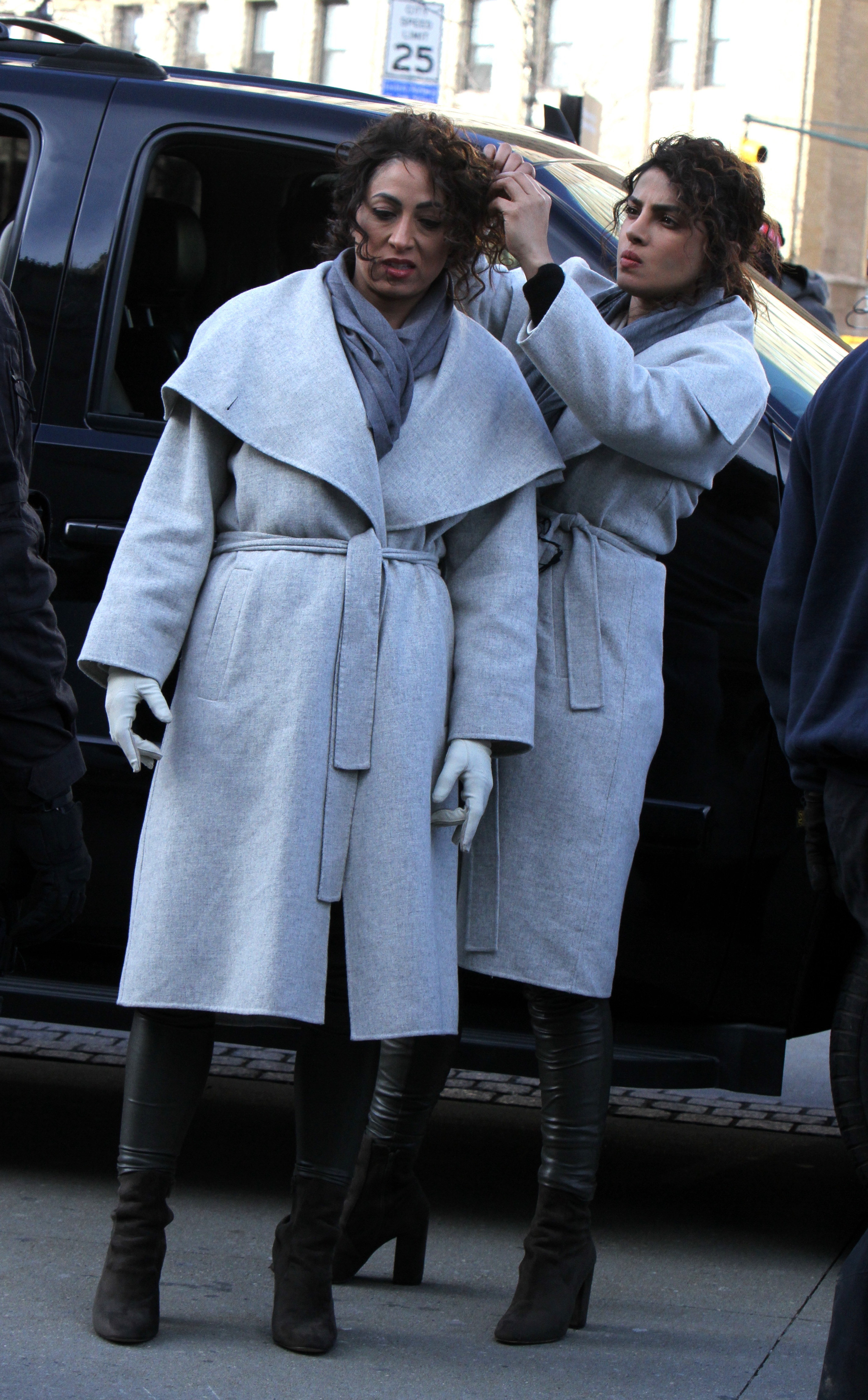 Chopra working on her body double&#x27;s hair next to a vehicle