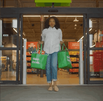 A women walking out of an whole foods grocery store