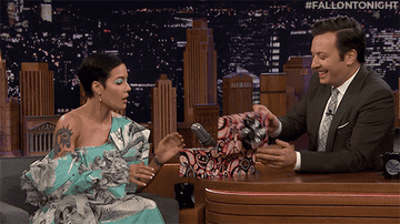 GIF of Halsey on the &quot;Tonight Show Starring Jimmy Fallon&quot; looking at a pair of blue jelly shoes