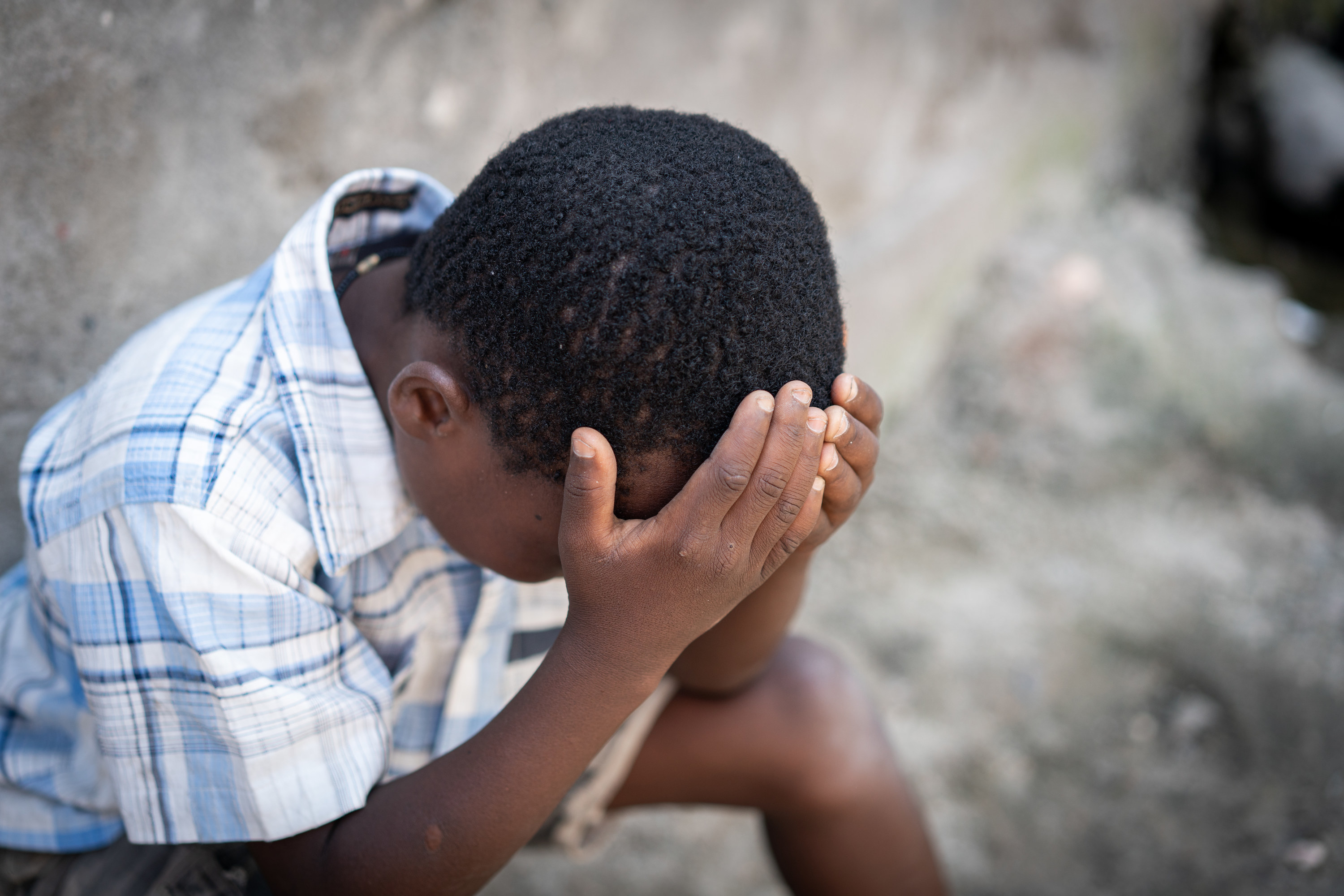 a young kid being sad outside