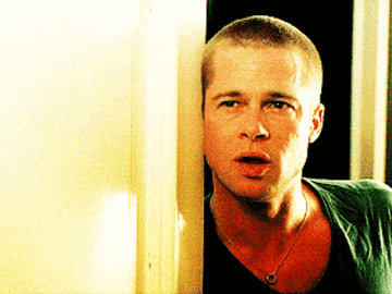Brad Pitt standing in a doorway and looking confused