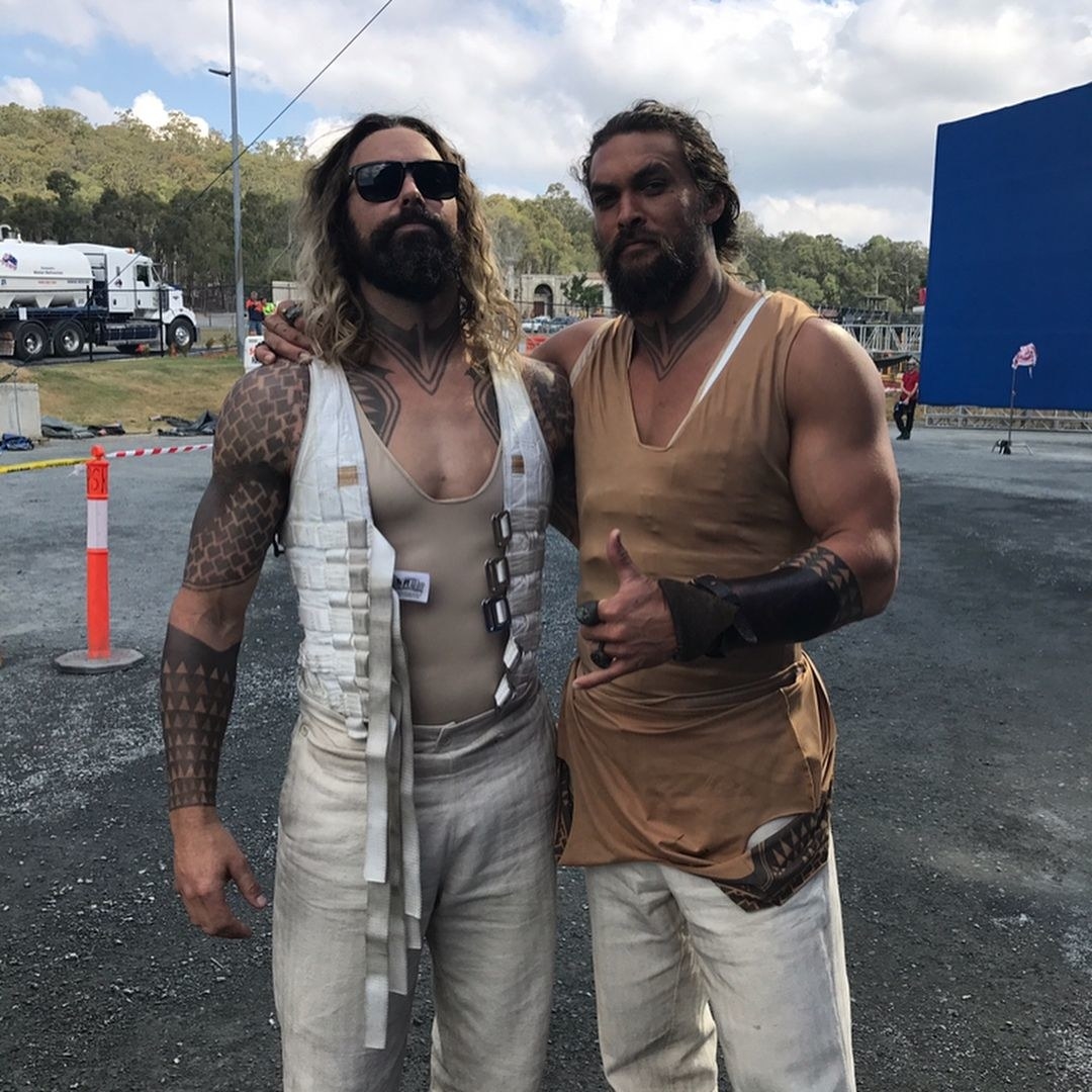Jason with his arm around his body double and giving a thumbs-up