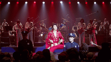 GIF of Elvis in various jumpsuits with his arms outstretched