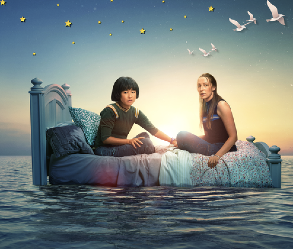 two main female characters from &quot;PEN15&quot; sitting on a bed