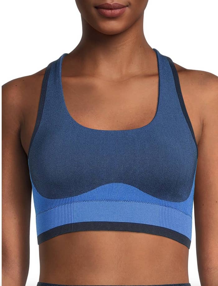 A person wearing a blue colorblock sports bra
