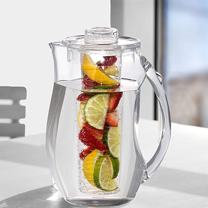 Water infuser pitcher with lemons, limes, and strawberries