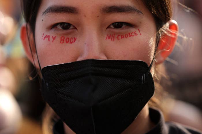 Pro-choice activist with &quot;my body my choice&quot; written on her face