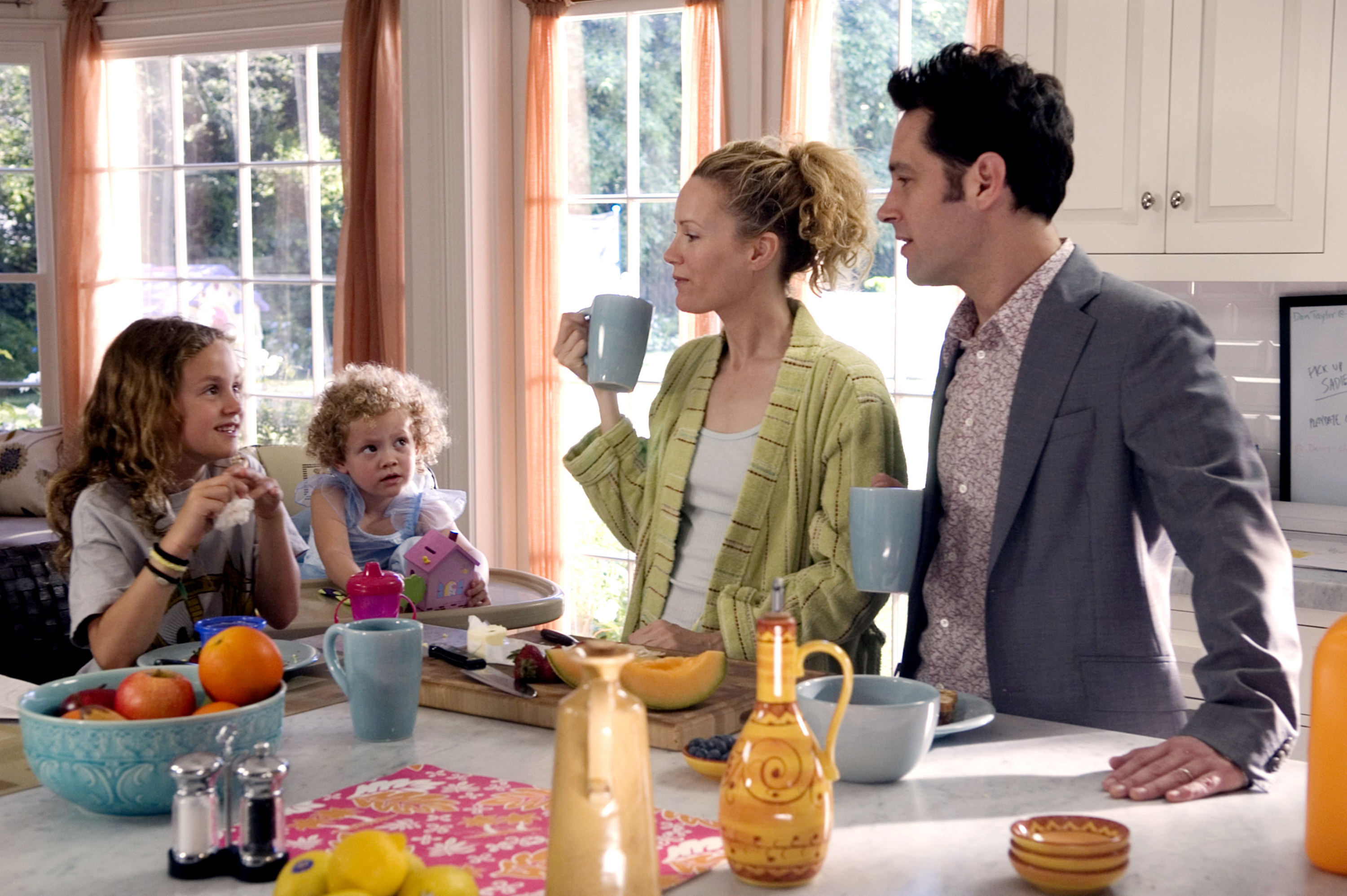 Leslie, her two daughters, and Paul Rudd around a kitchen table