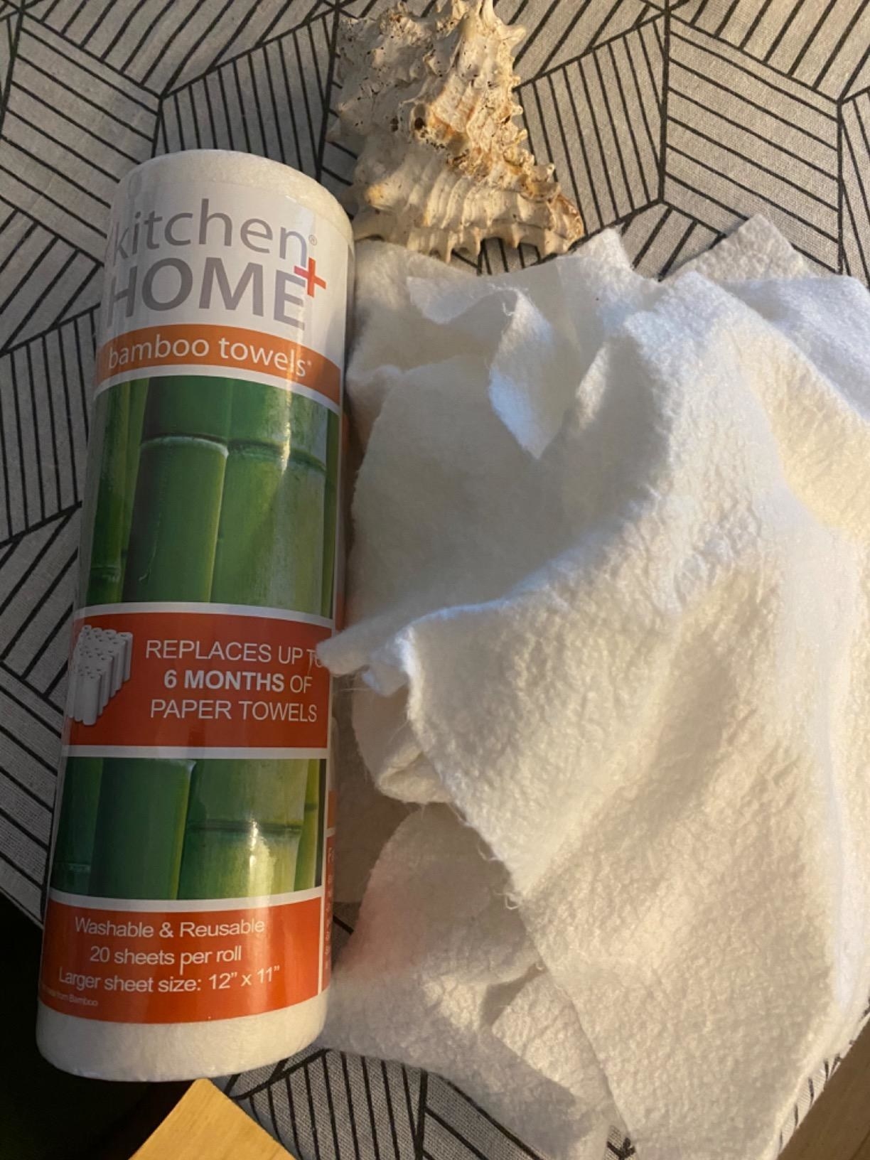 Reviewer&#x27;s photo of bamboo paper towels spread out next to the roll