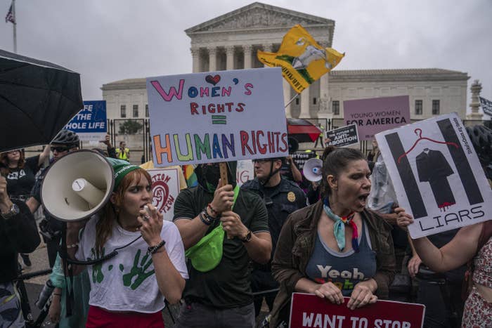 Abortion-rights activists chant during a rally in front of the Supreme Court