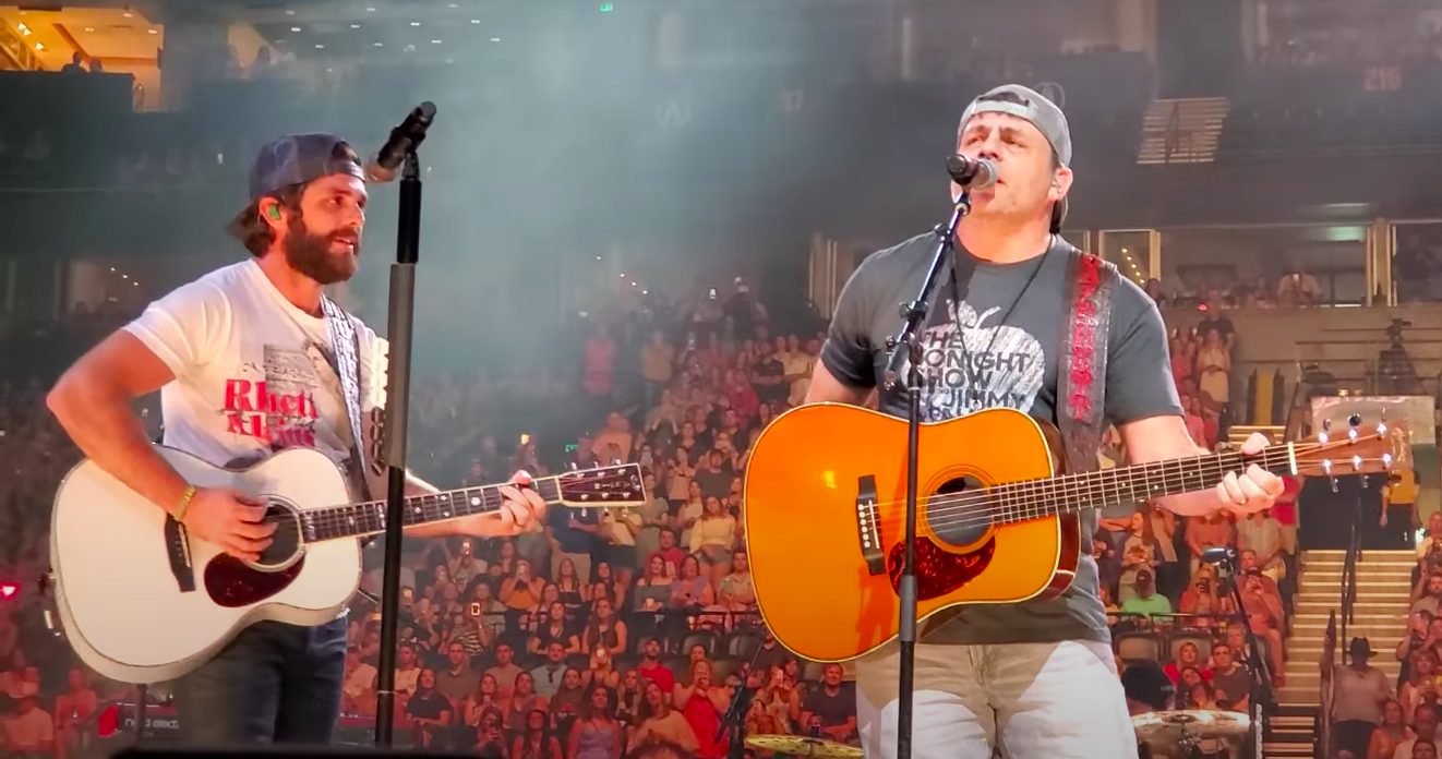 the two playing guitar on stage