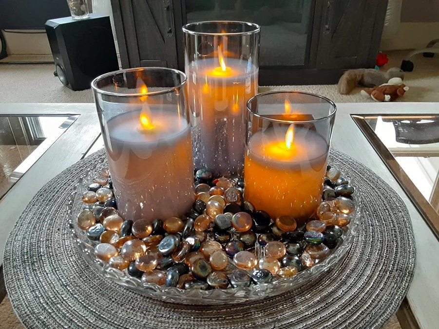 Reviewer image of three flameless candles in a glass dish filled with colorful pebbles