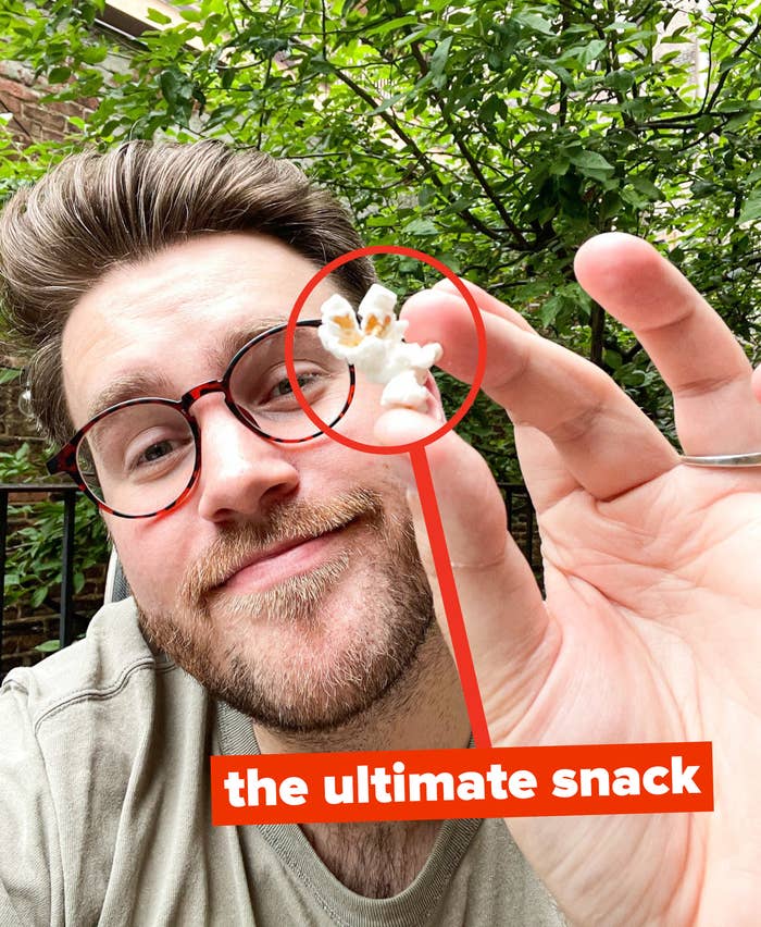 the author showing a piece of popcorn with the words &quot;the ultimate snack&quot;