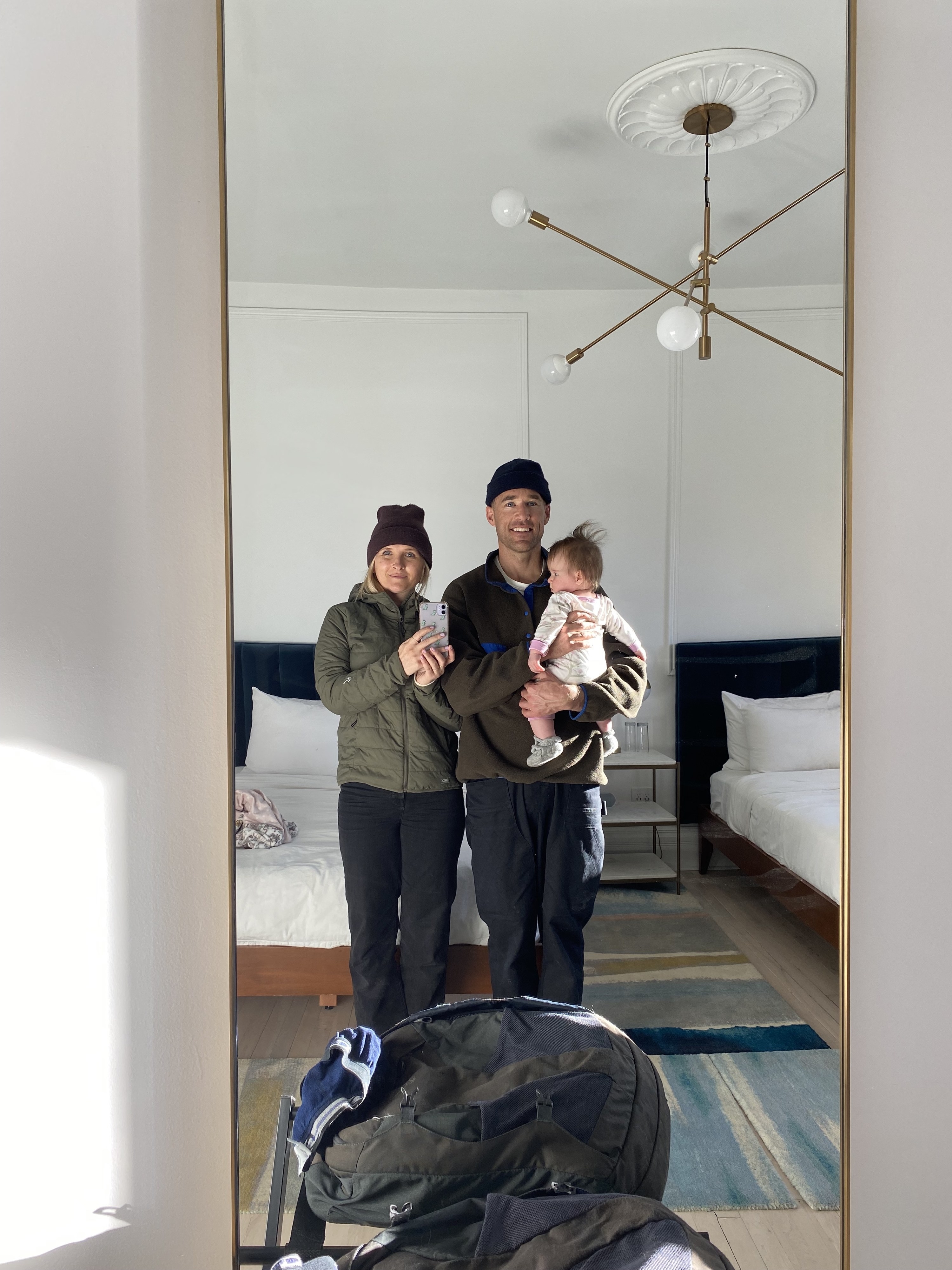 Family takes photo in a mirror of a hotel