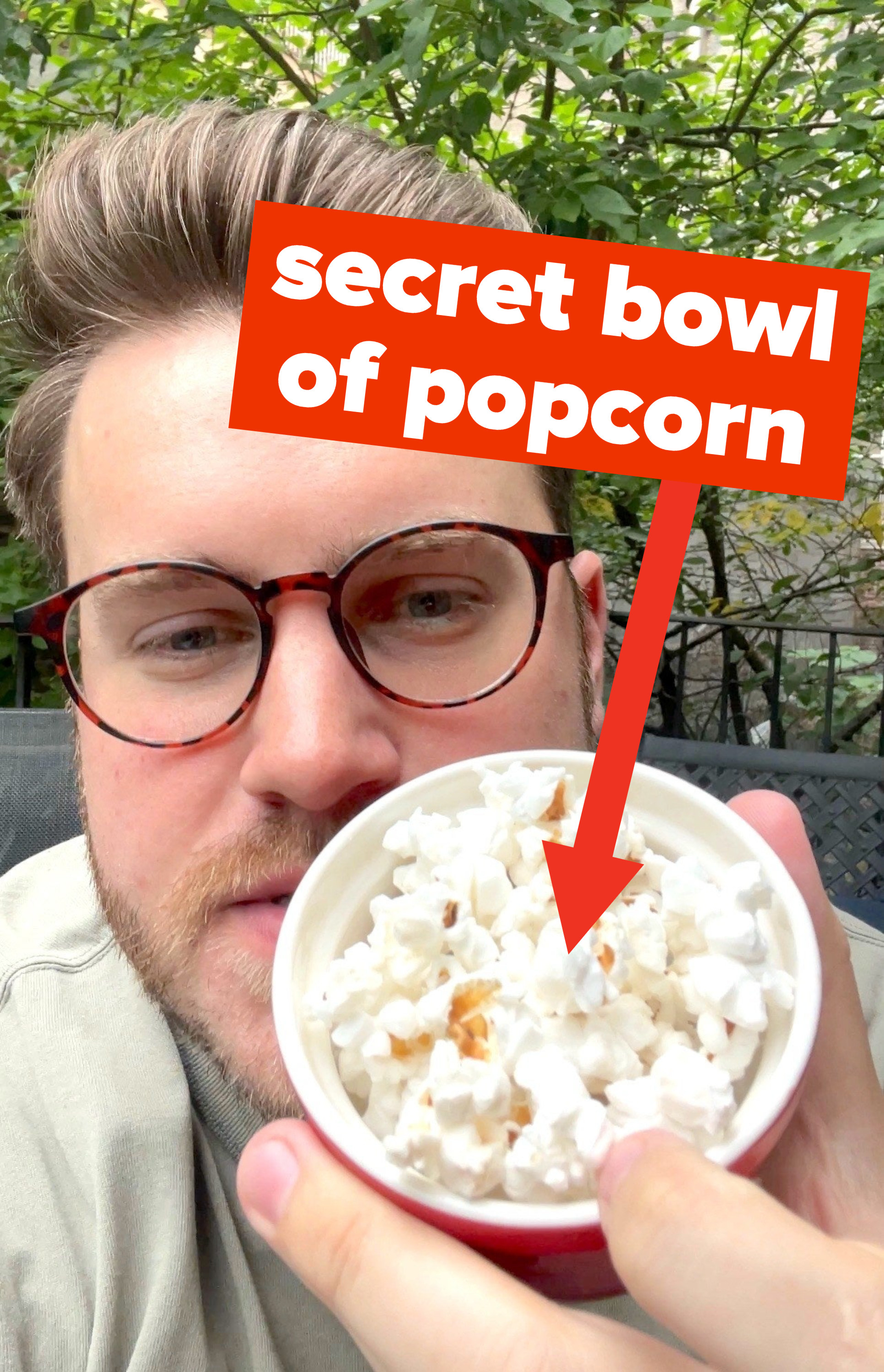 the author holding a cup of popcorn with the words &quot;secret bowl of popcorn&quot;