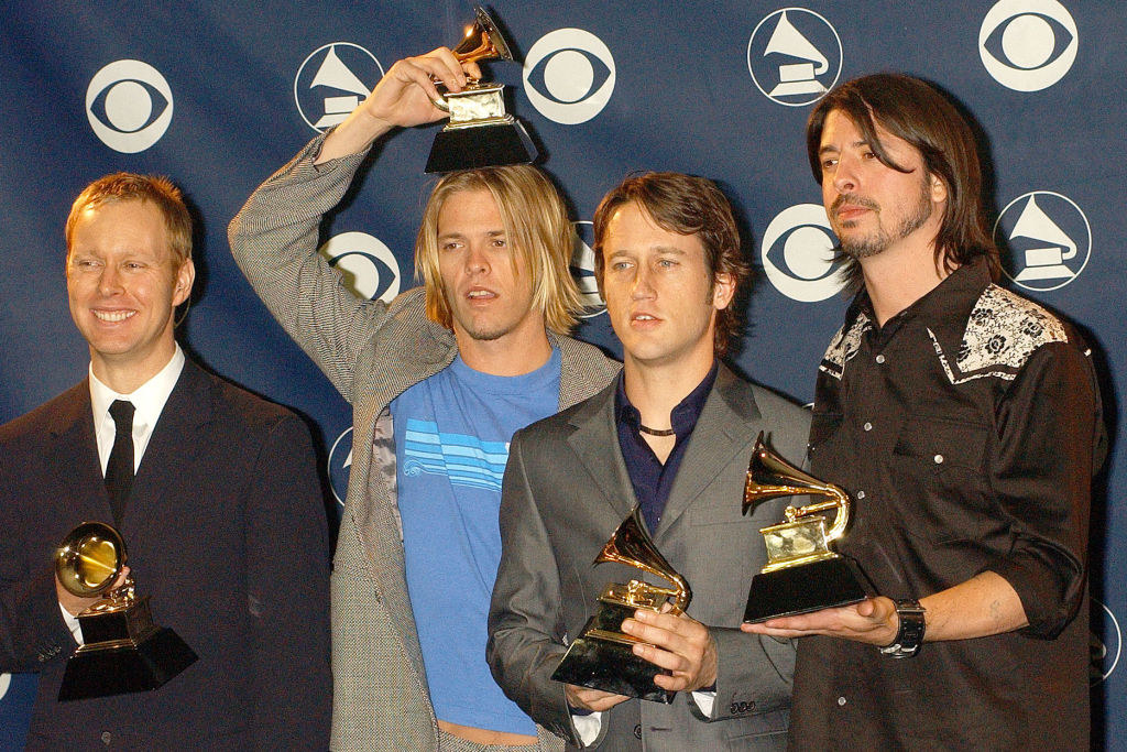 Foo Fighters holding their Grammys