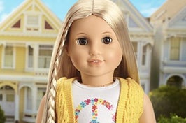 julie albright american girl doll who has long straight hair and wears a knit vest over a t shirt
