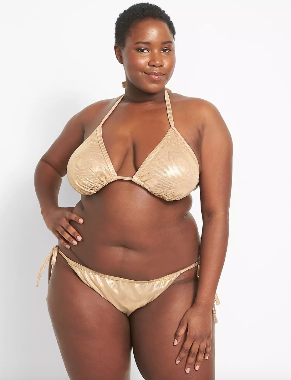 a model wearing the gold bikini