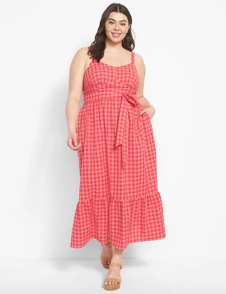a model wearing the pink and red gingham dress