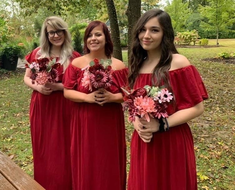 three bridesmaids wearing the dress in wine