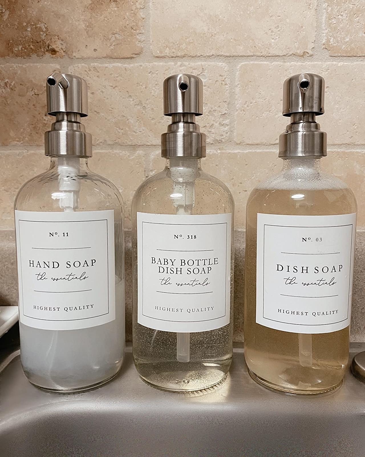 Reviewer image of three soap dispensers with white labels
