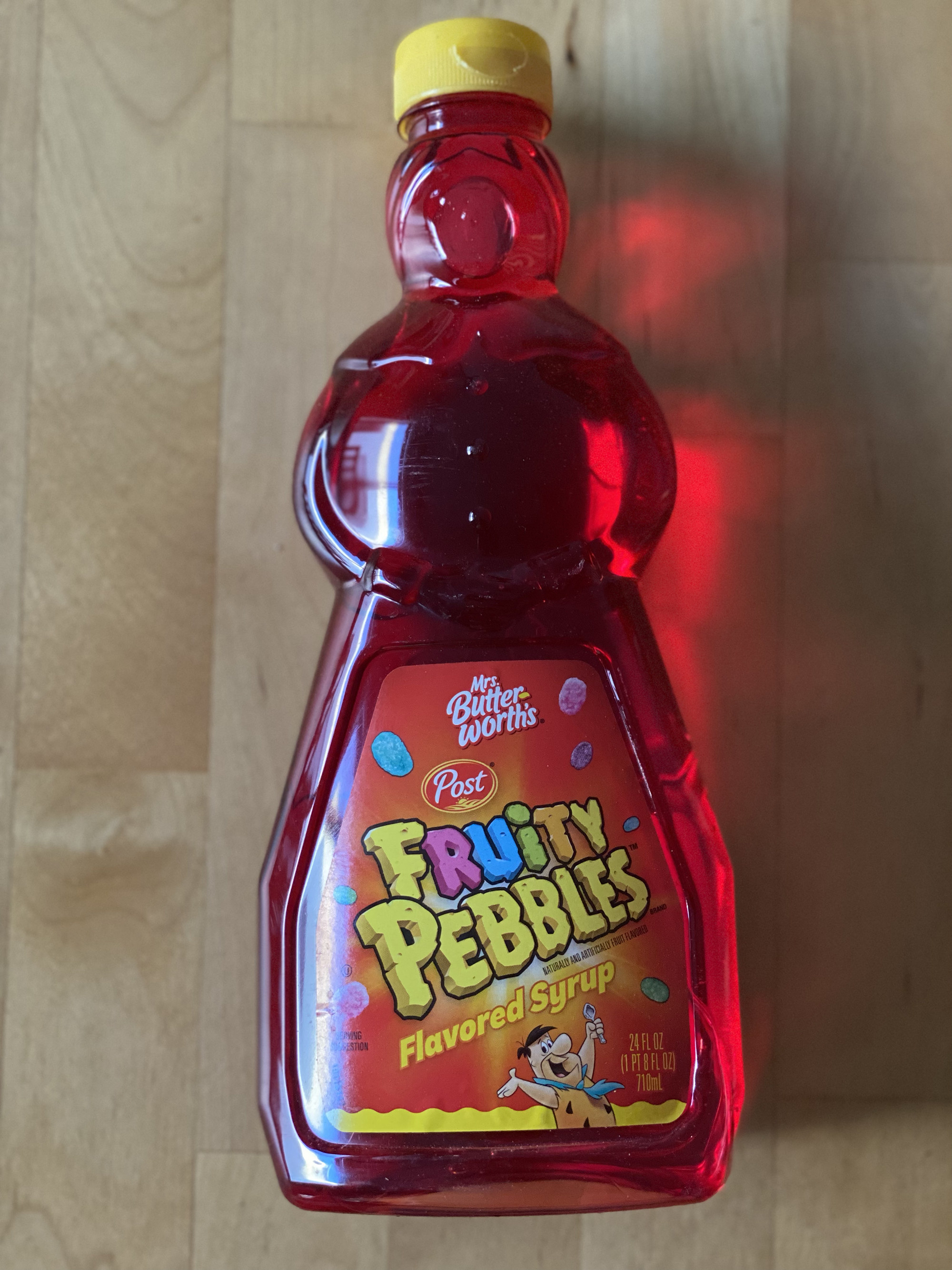 A bottle of Mrs Butterworth&#x27;s Fruity Pebbles flavored syrup