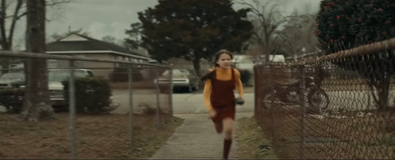 Gwen running with a rock in her hand