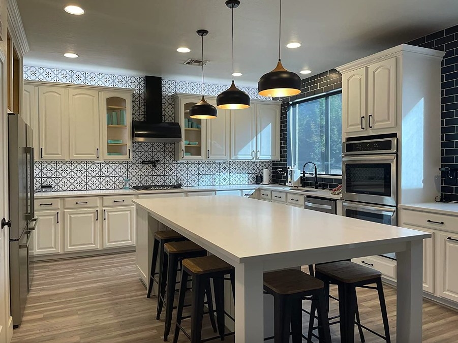 Reviewer image of three black pendant lights above kitchen island