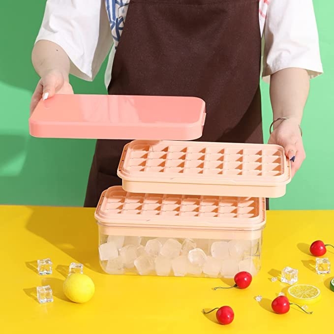 Person holding parts to ice tray