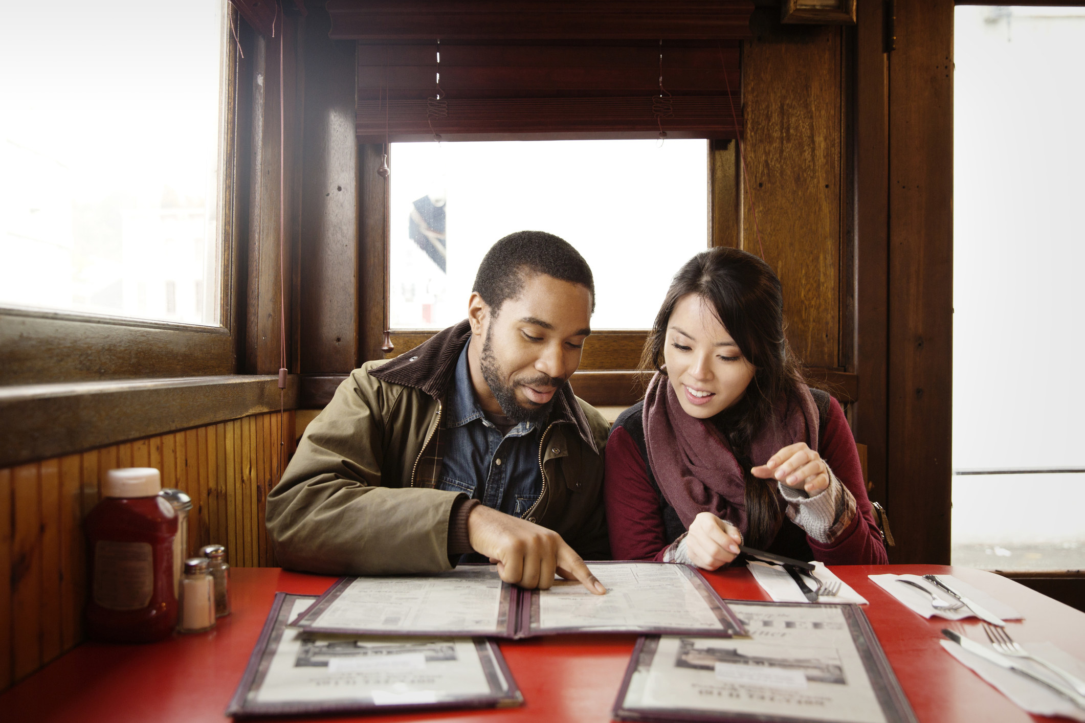 two people looking at a menu