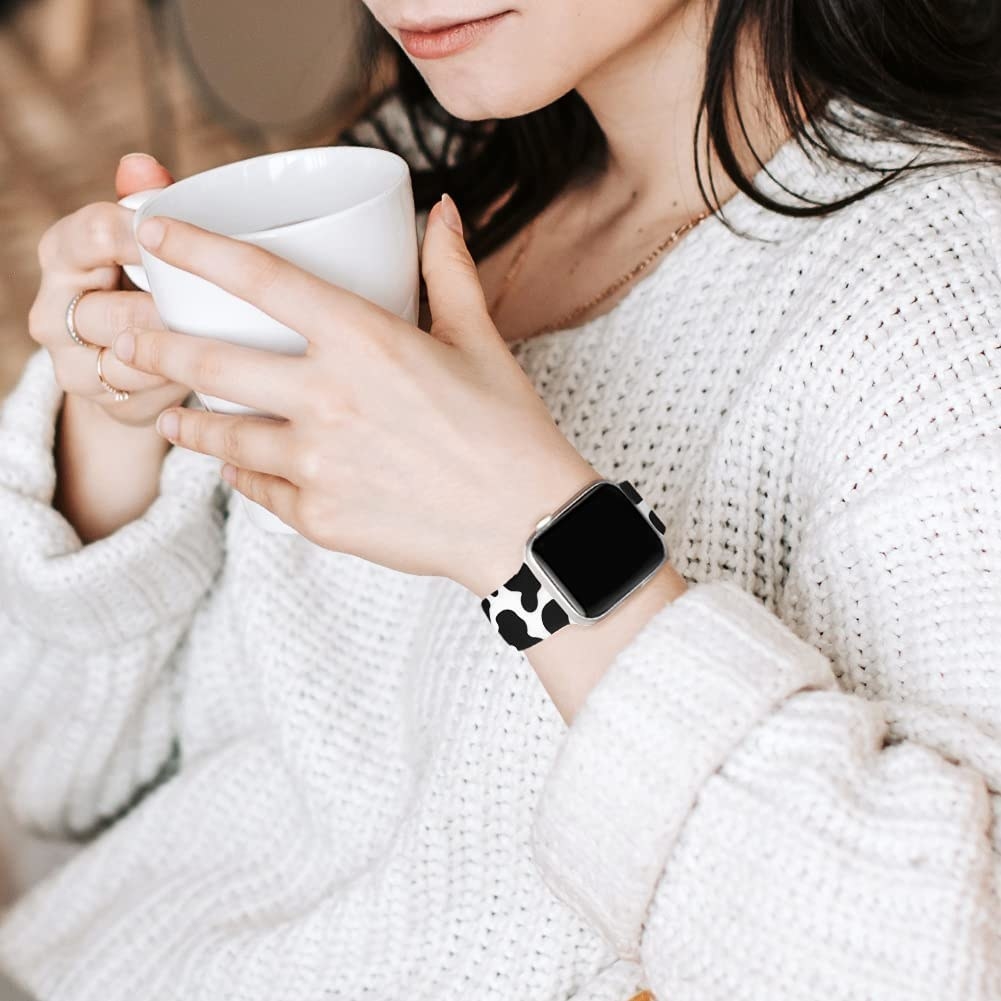 person sipping a coffee with the watch on