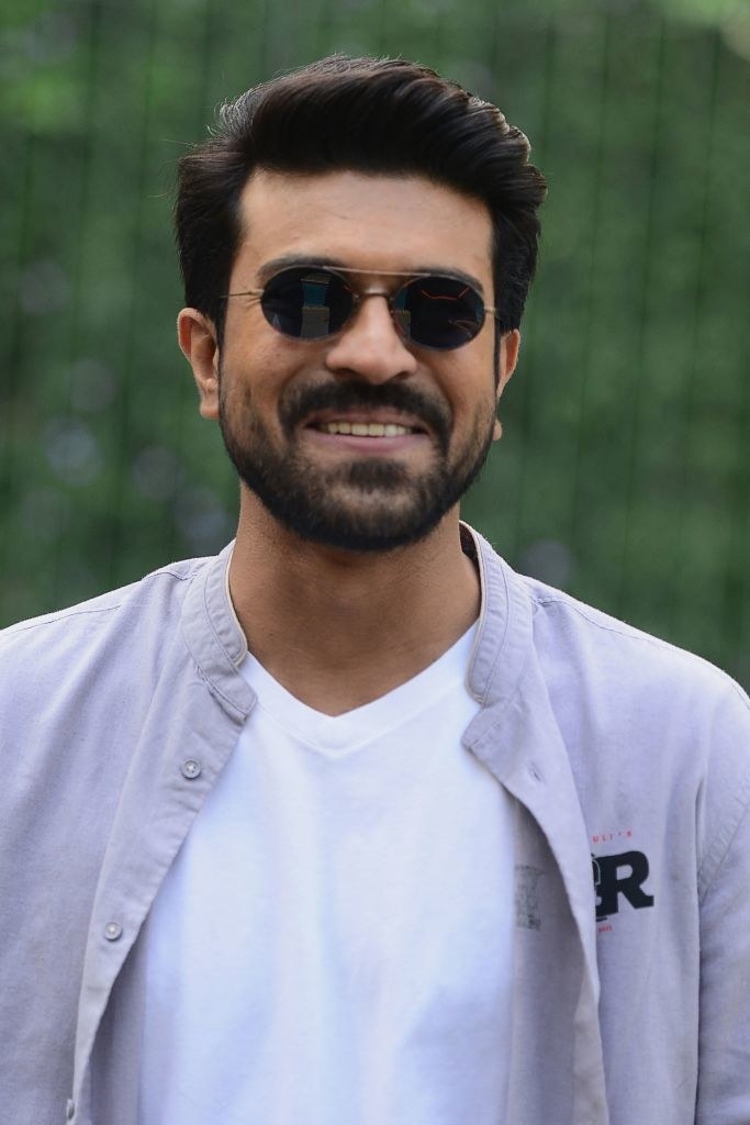 Ram Charan, wearing sunglasses poses for a picture