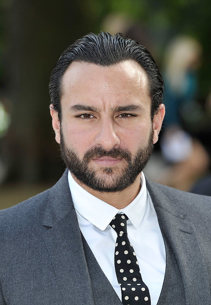 Saif Ali Khan, wearing a suit and tie, poses for a picture