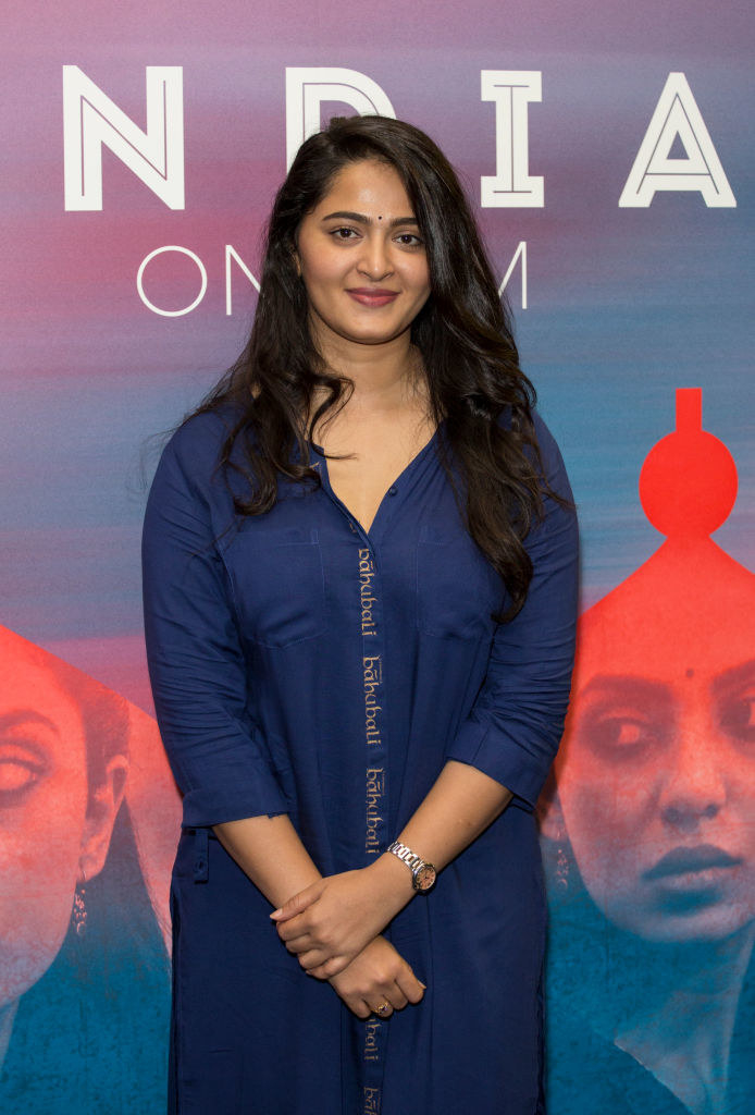Anushka Shetty smiles and poses for a picture with her hands crossed