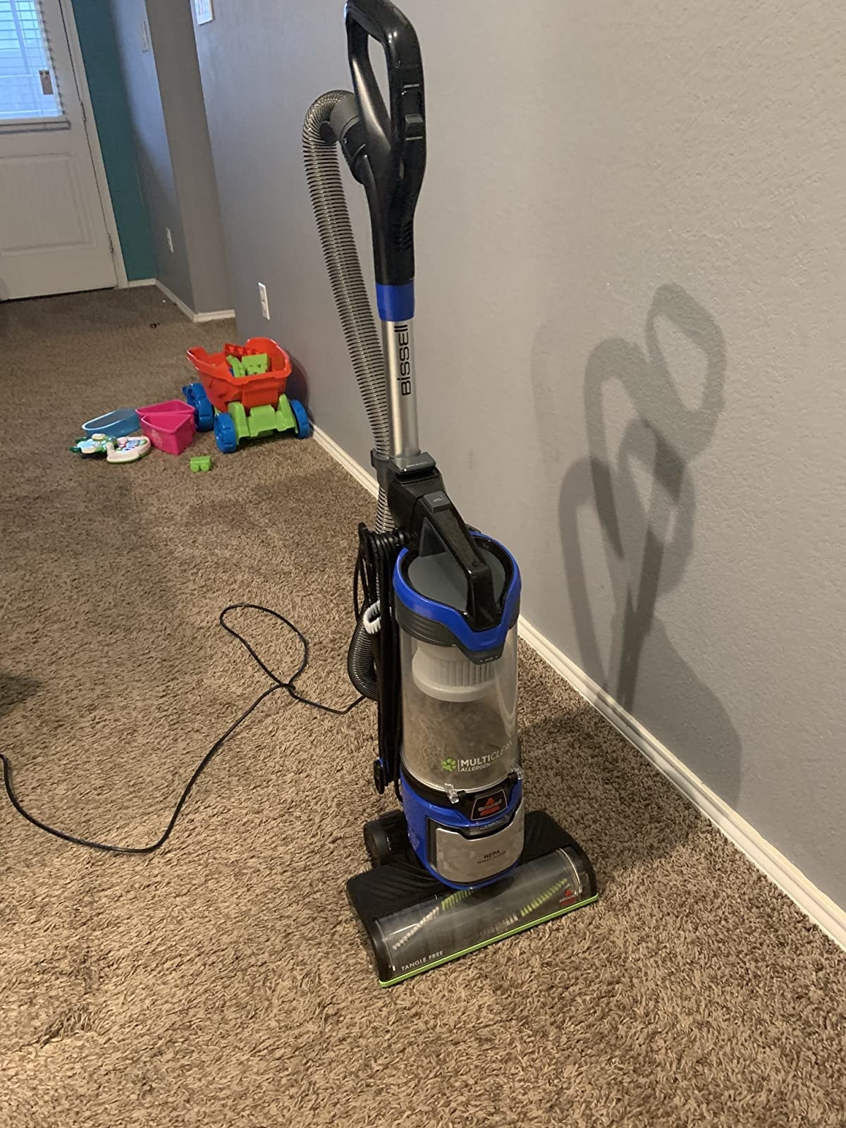 reviewer&#x27;s photo of the upright corded vacuum on carpet