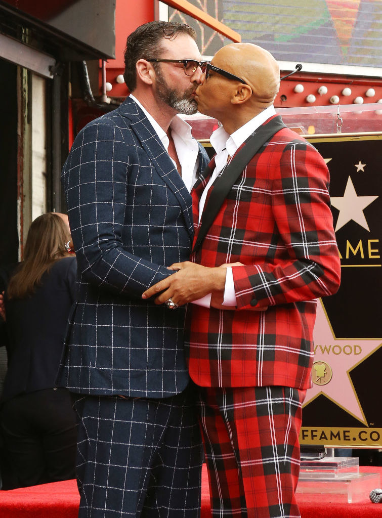 LeBar and RuPaul kissing and wearing plaid suits