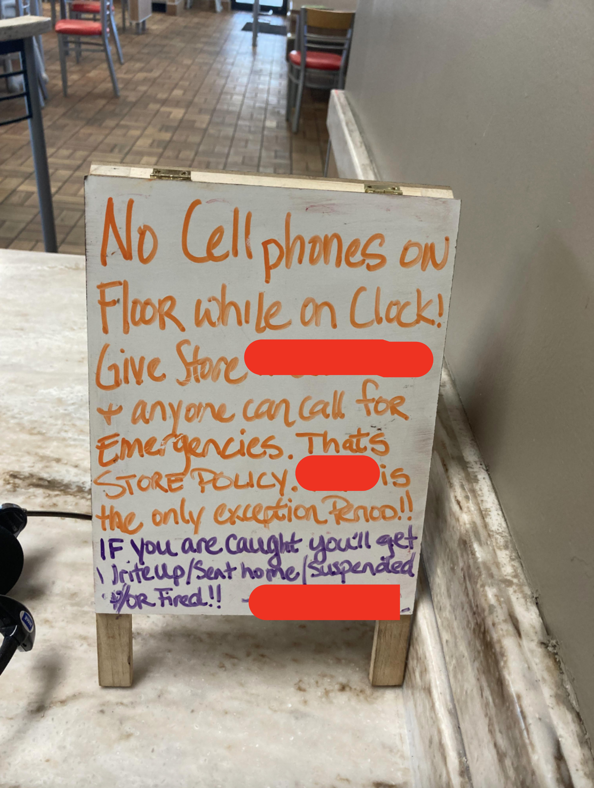 a sign saying no cellphones while on the clock