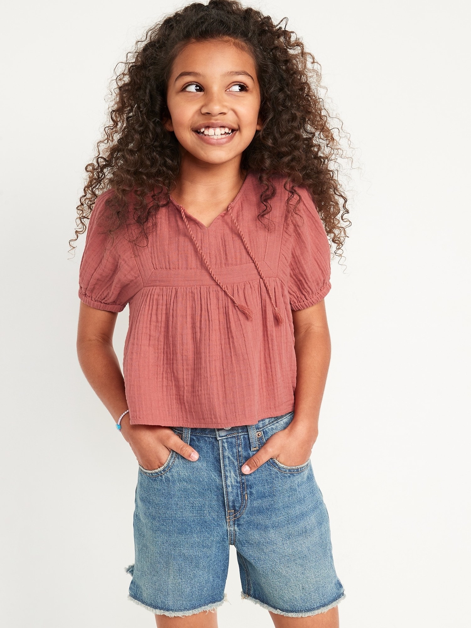 a child wearing the puff sleeve top in a clay color