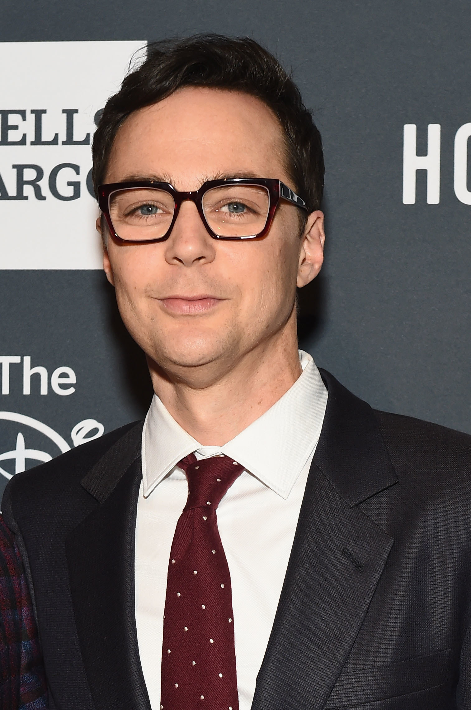 Clean-shaven Jim wearing glasses and in a suit and tie