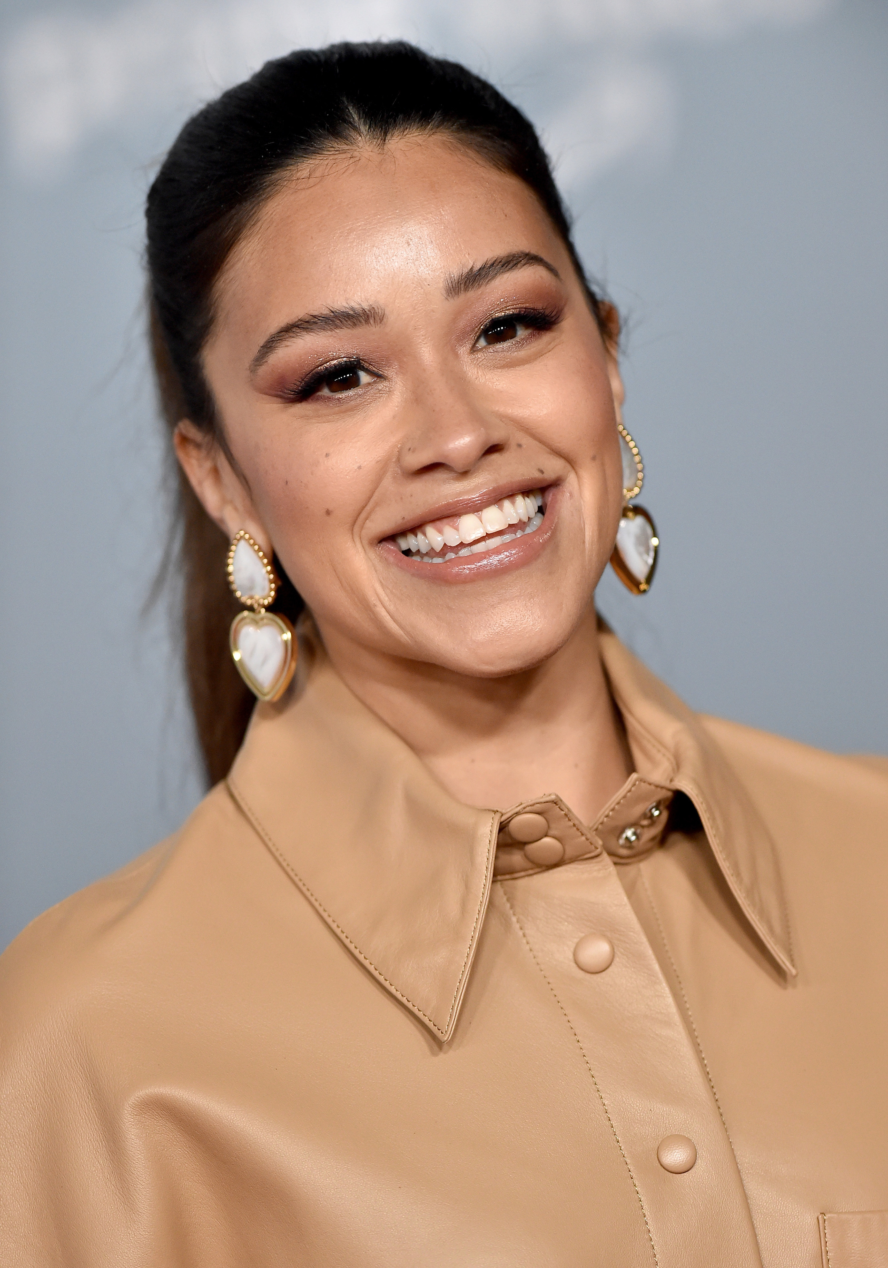 Smiling Gina in a button-front jacket with collar